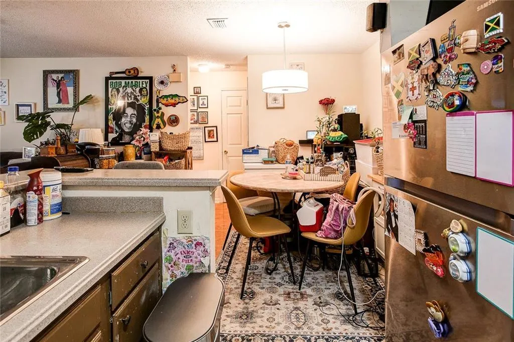 Dining room featuring sink and a textured ceiling