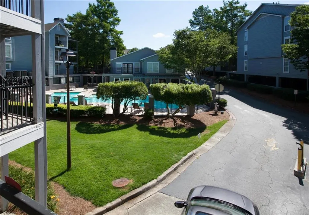 View of nearby features featuring a swimming pool and a lawn