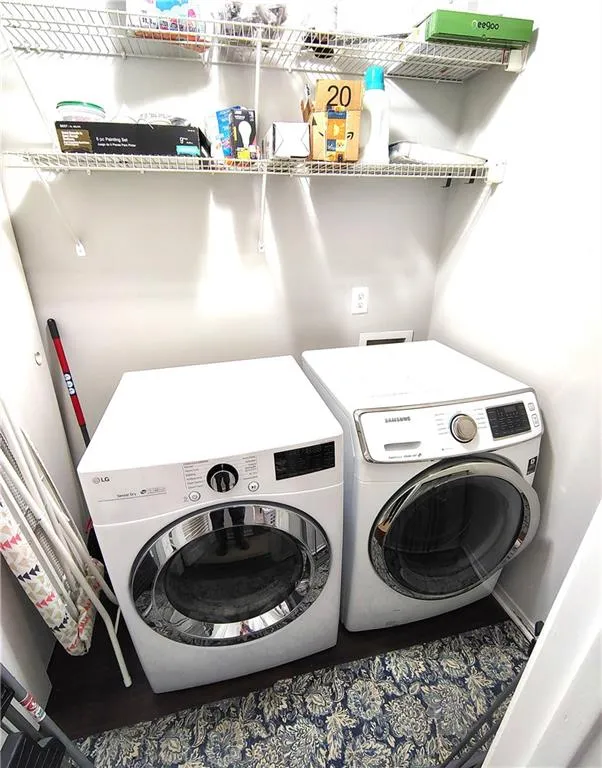 Clothes washing area featuring washer and dryer and laundry area