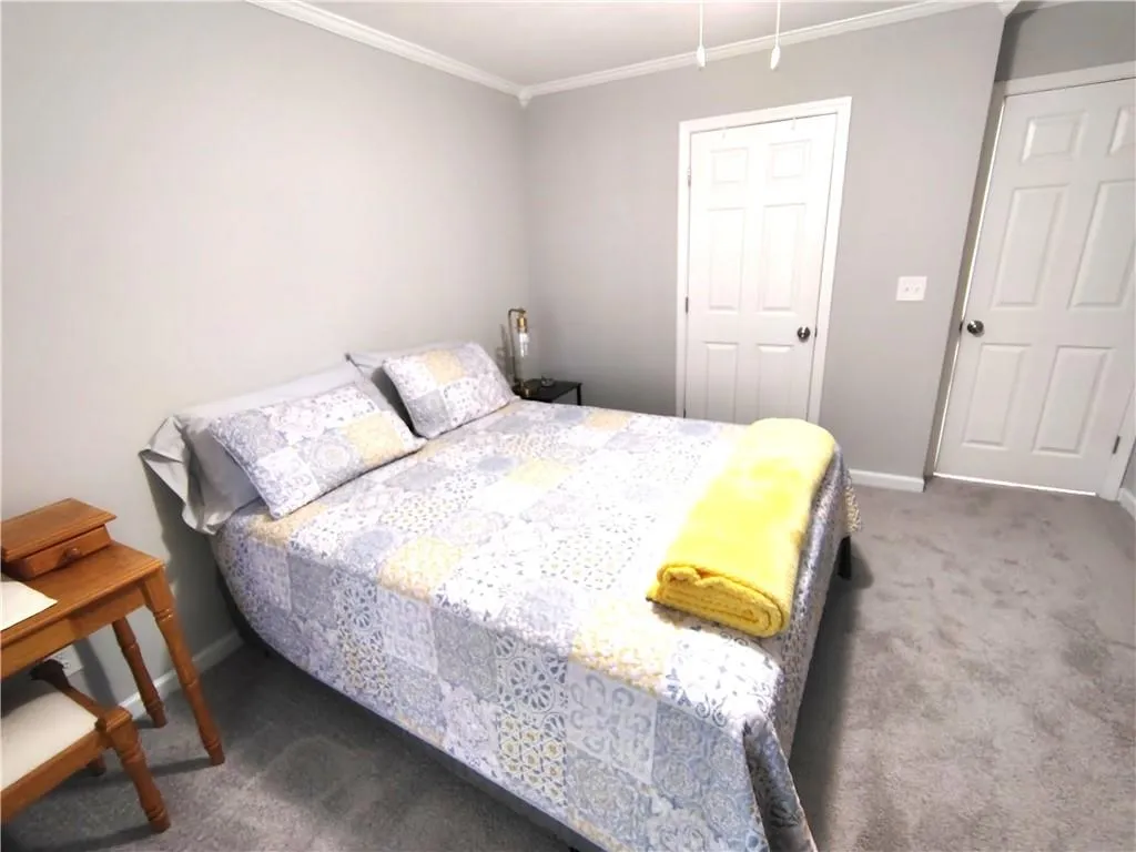 Bedroom2  featuring carpet floors, crown molding, and baseboards