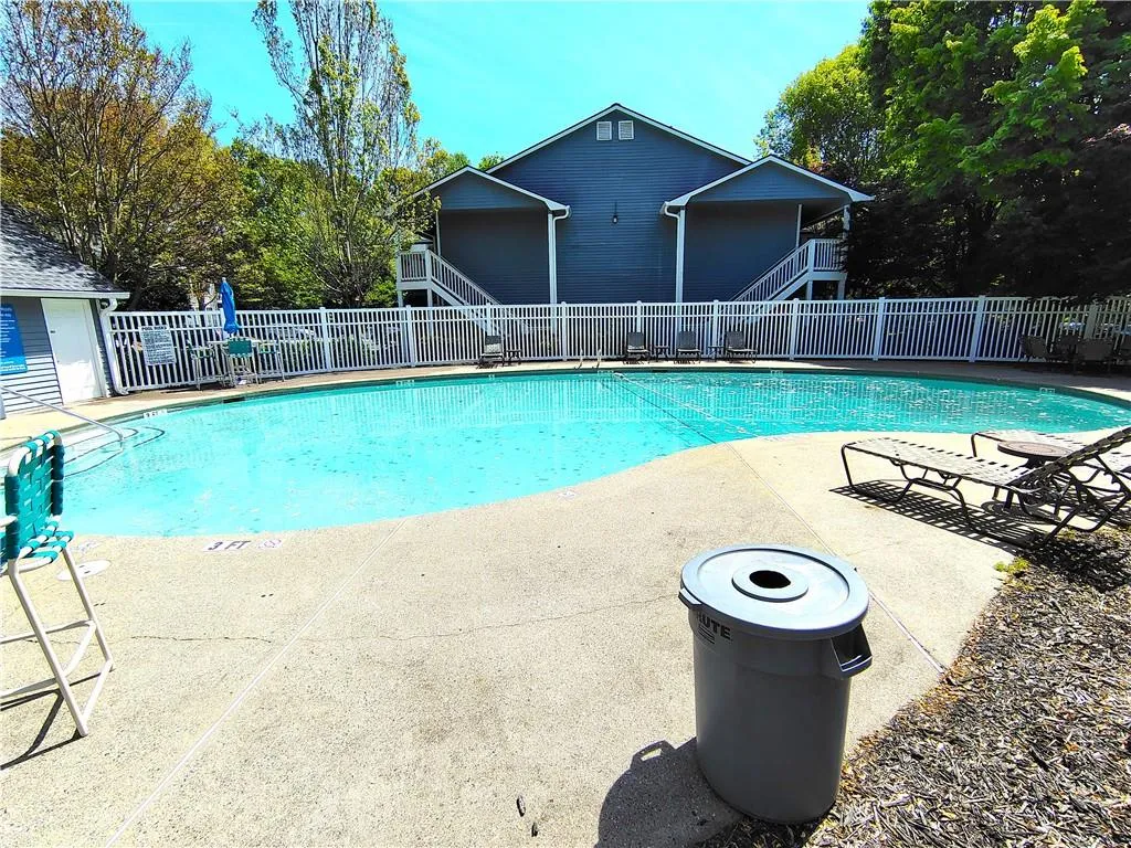 Pool featuring fence and a patio