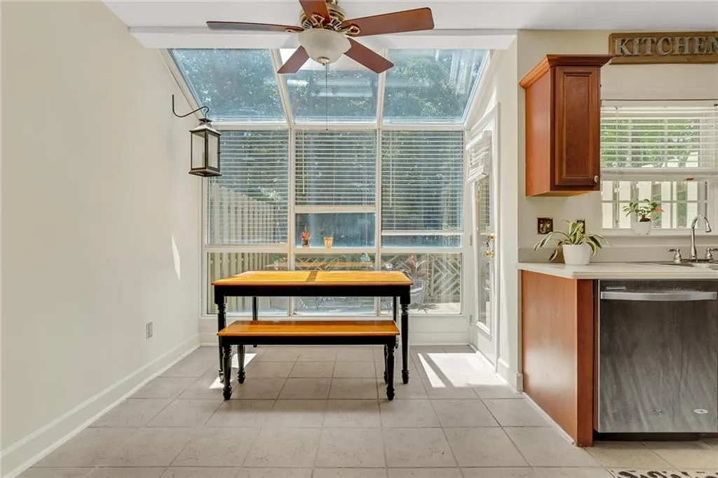 Dining area with sink, ceiling fan, and light tile patterned floors