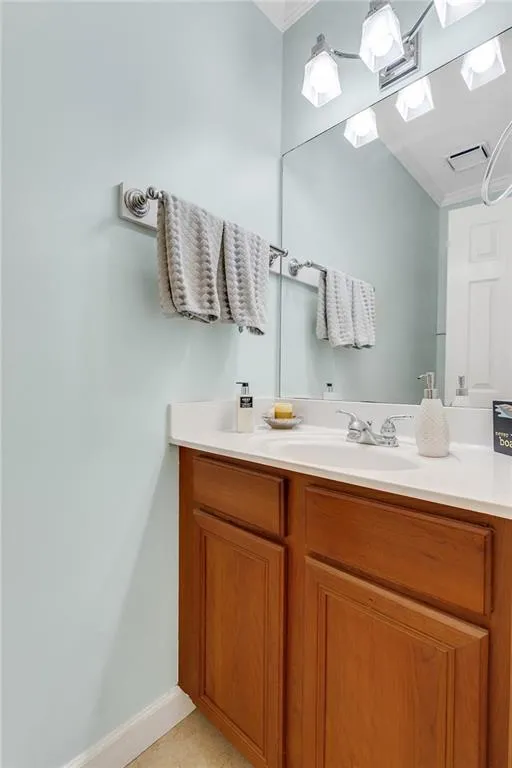 Bathroom featuring vanity and crown molding