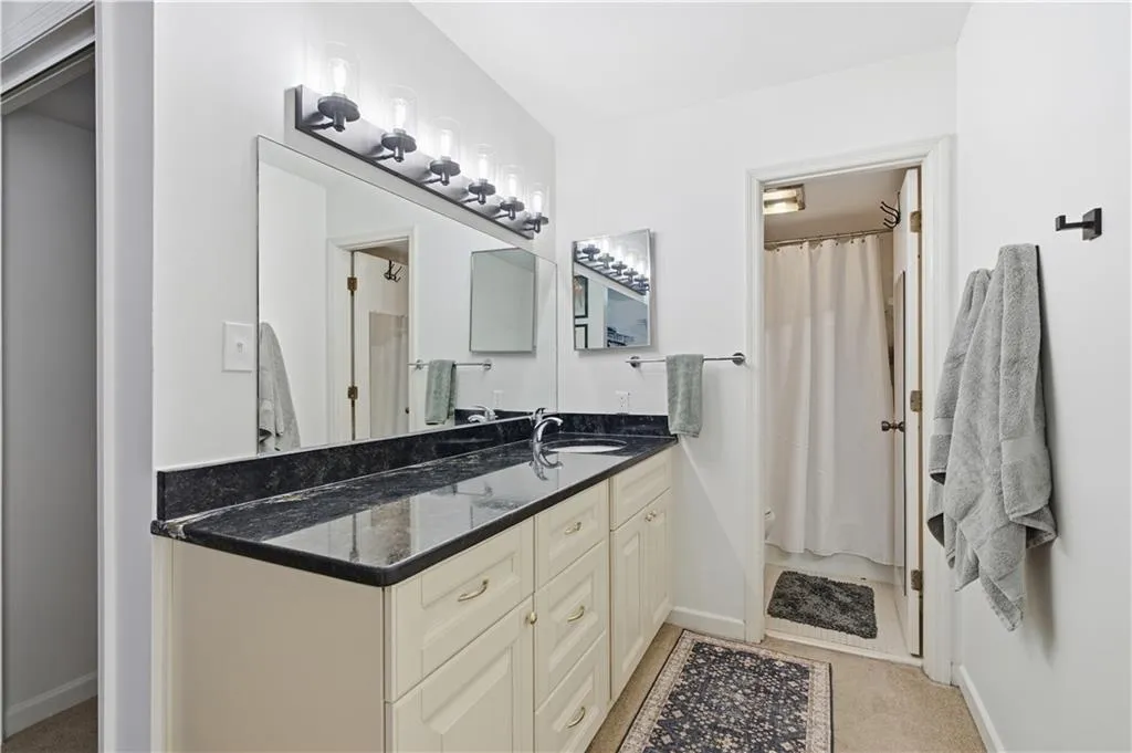 Double vanity with a dark countertop and undermount sink