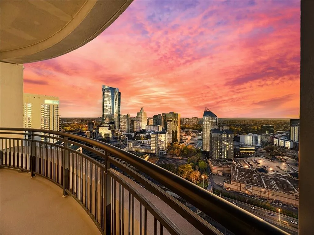 Balcony at dusk with a view of city