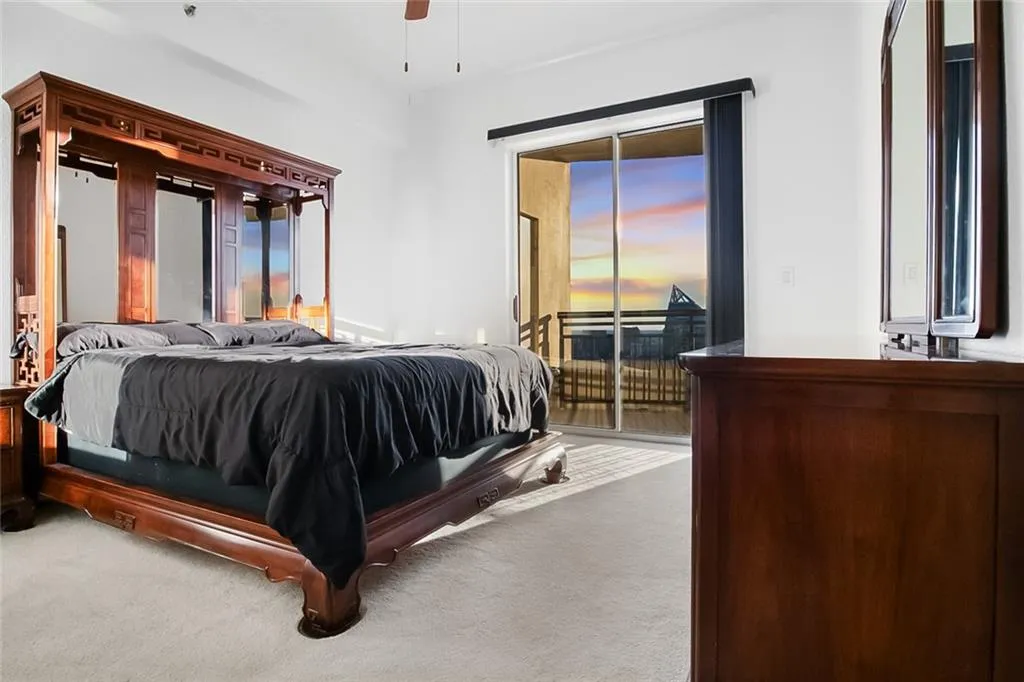 Carpeted bedroom with access to outside