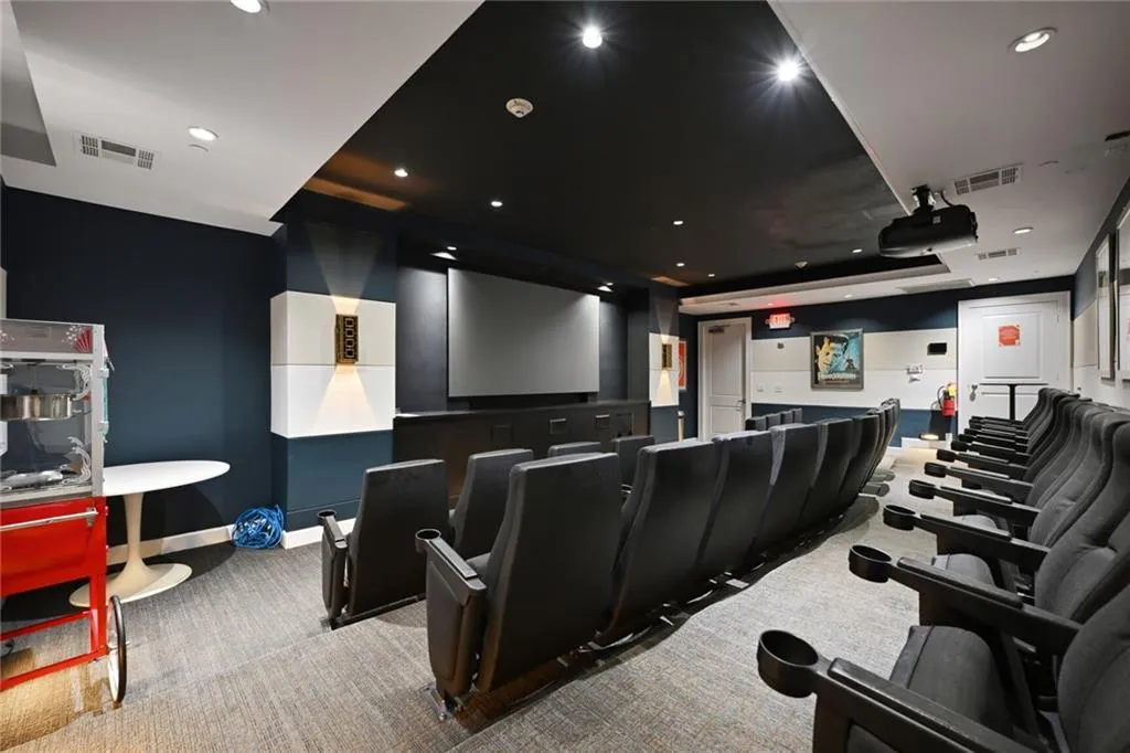 Home theater featuring light carpet