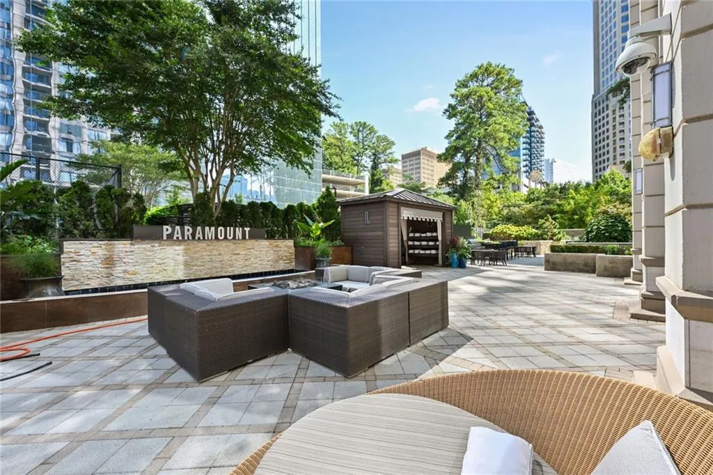 View of patio featuring an outbuilding and an outdoor living space with a fire pit
