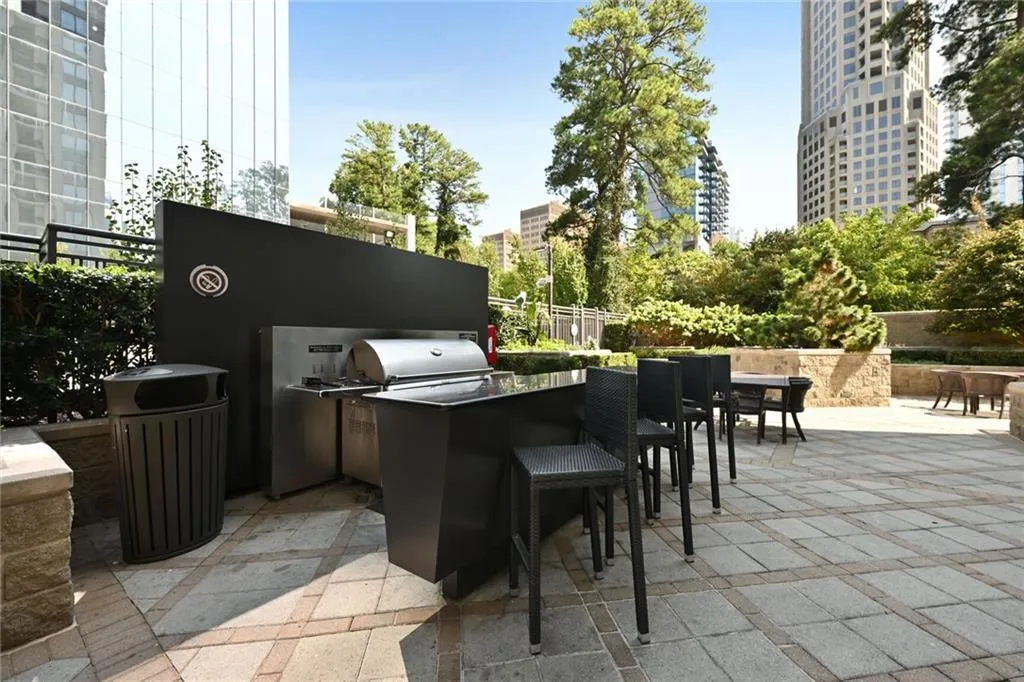 View of patio with area for grilling and an outdoor kitchen