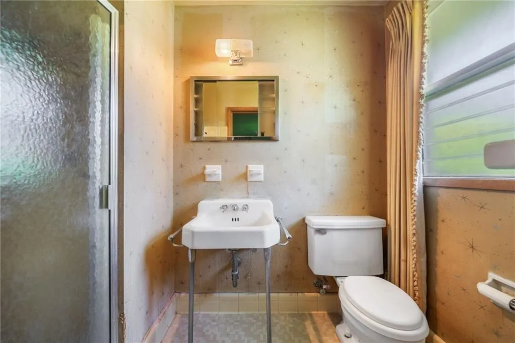 Bathroom with toilet and tile patterned floors