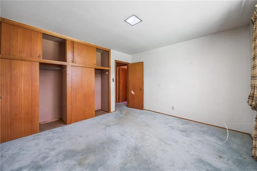 Unfurnished bedroom featuring a closet and carpet flooring