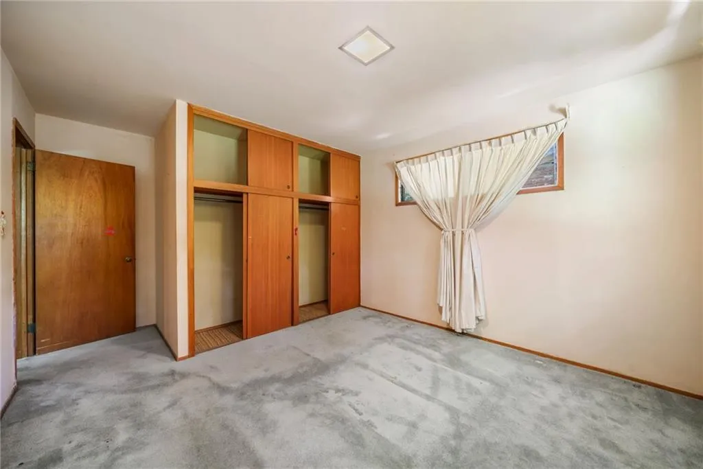 Unfurnished bedroom with a closet and carpet floors