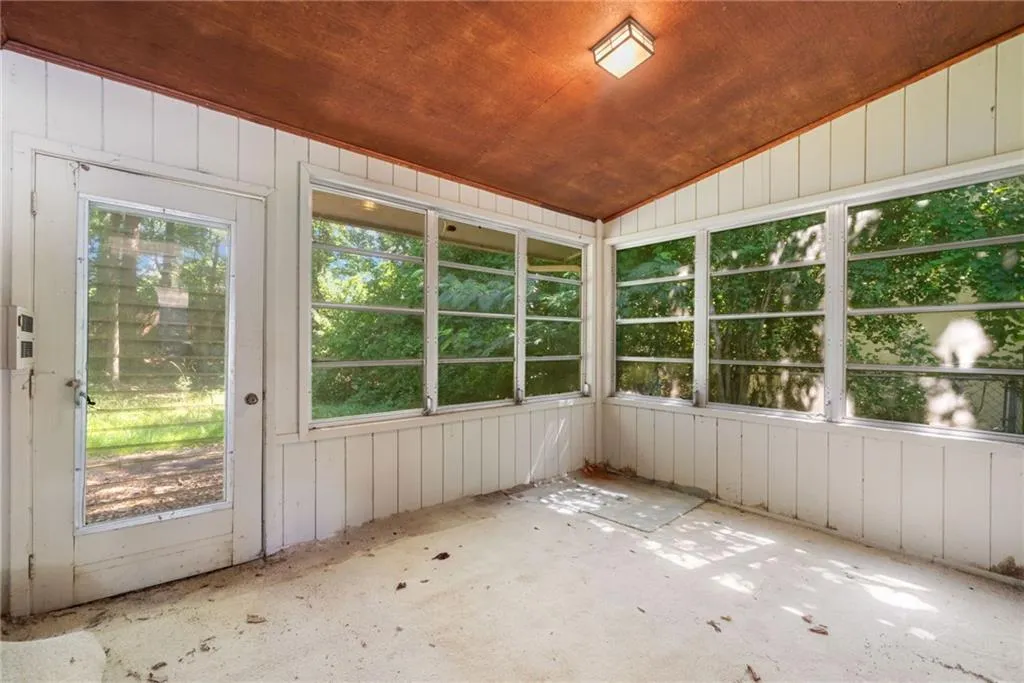 Unfurnished sunroom with plenty of natural light