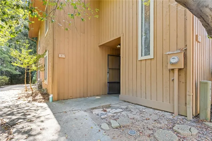 Wood siding exterior with vertical paneling, showcasing a recessed entry and a multi-paned window