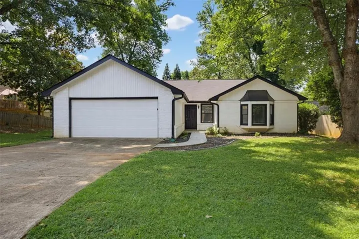 White painted brick exterior with a black trim roofline