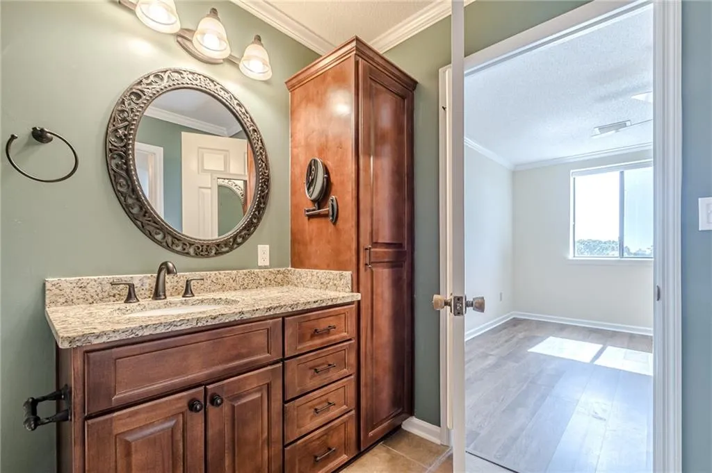 Bathroom with vanity, hardwood / wood-style floors, and ornamental molding