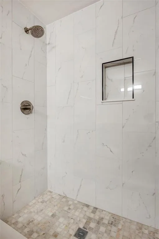 Bathroom featuring a tile shower