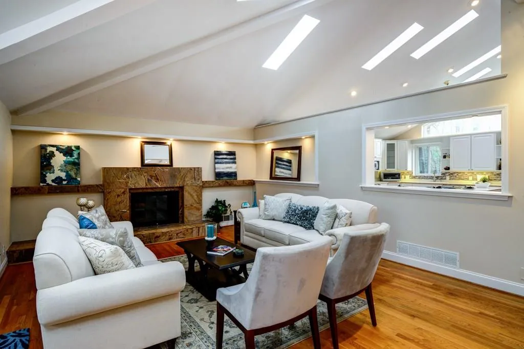Fireside family room with custom shelving and view to kitchen