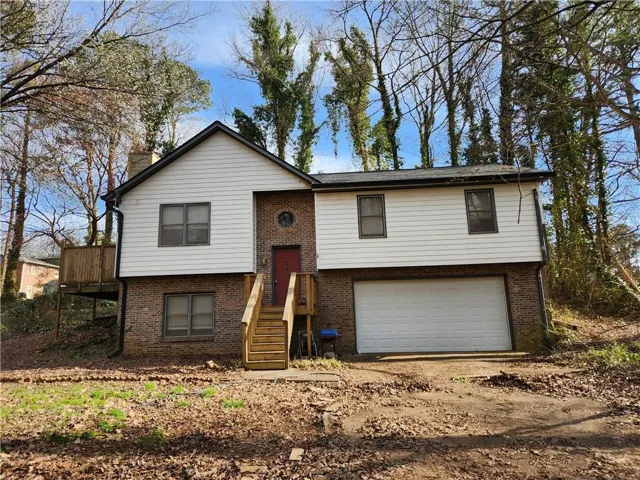 Brick and siding exterior with a prominent attached garage