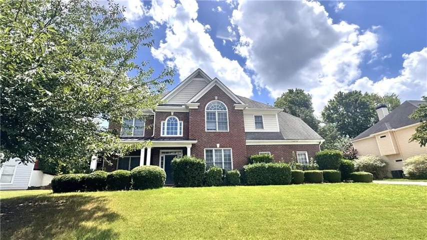 Brick facade residence with multiple gables and a covered entry