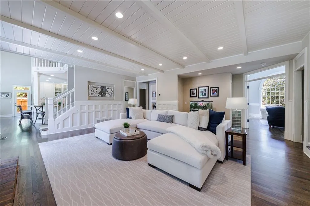 Living room with hard wood flooring and beamed ceiling