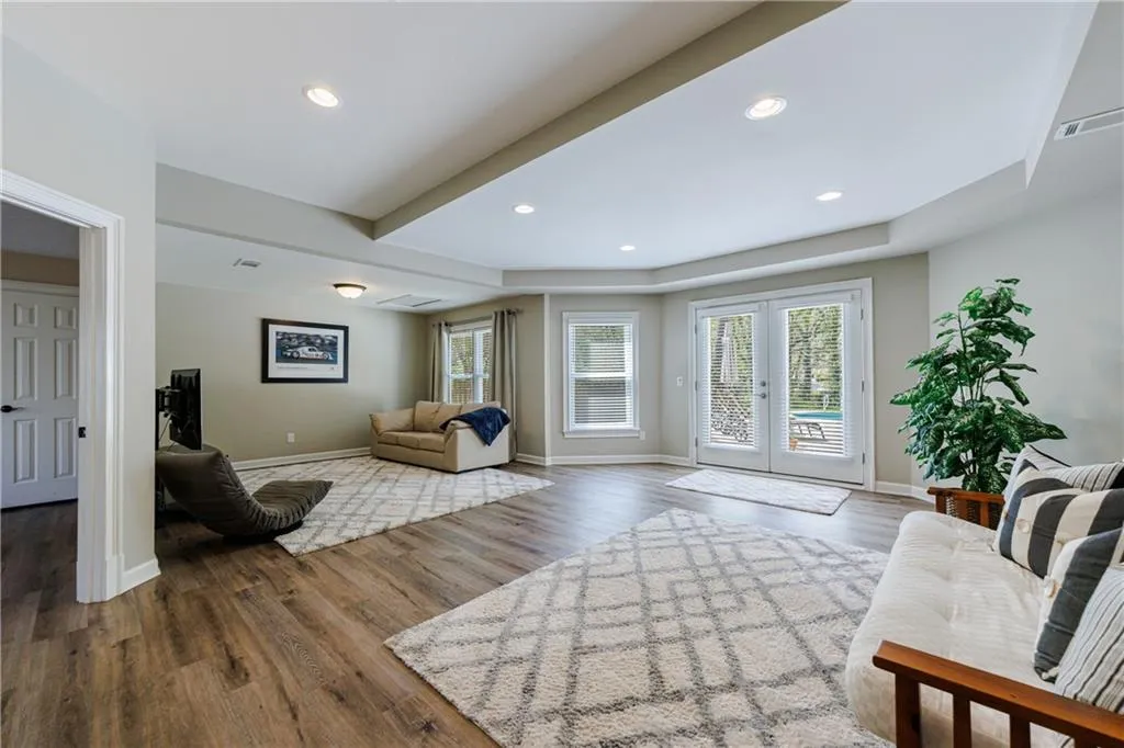 Living area with dark wood-style floors and french doors
