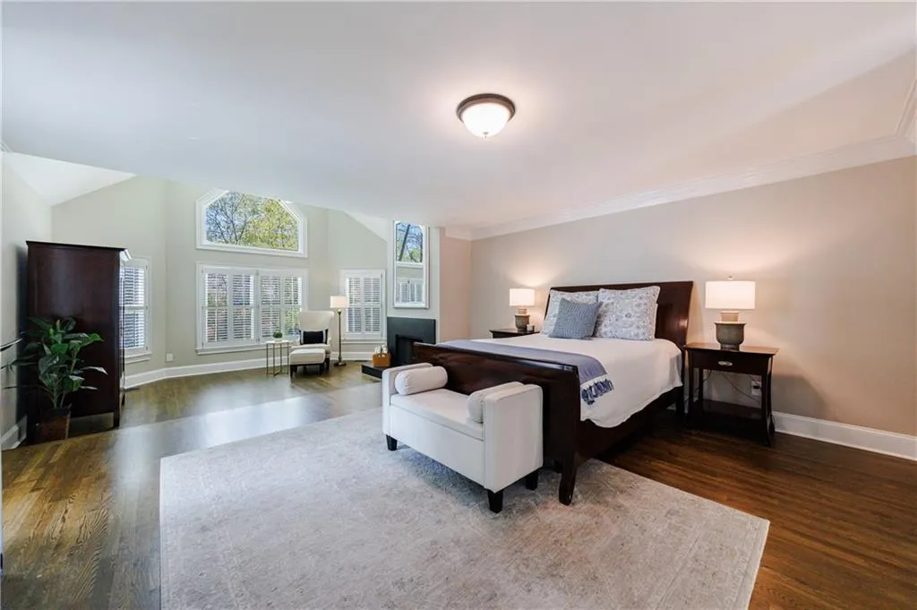 Master Bedroom with crown molding and hardwood flooring
