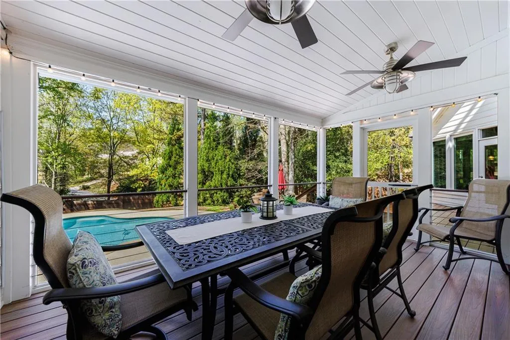 Sunroom / solarium featuring wooden ceiling,  ceiling fans, and a wealth of natural light