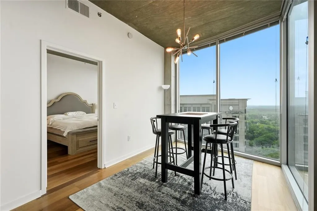 Floor-to-ceiling windows with expansive urban and treeline scenery