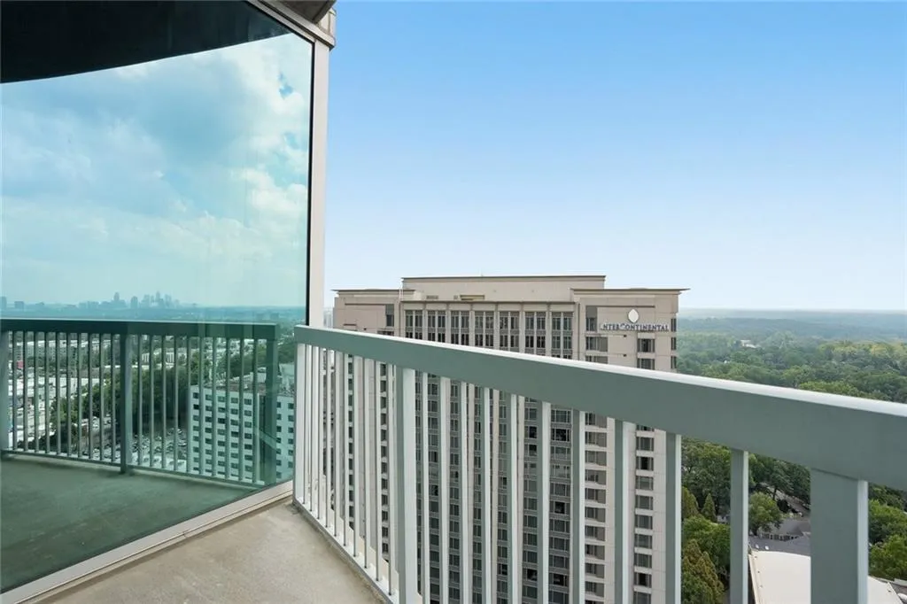 Private balcony with a concrete floor and metal railing