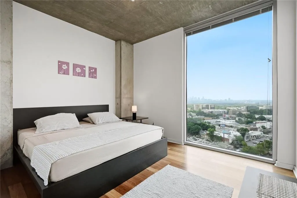 Floor-to-ceiling window offering expansive urban and distant cityscape scenery