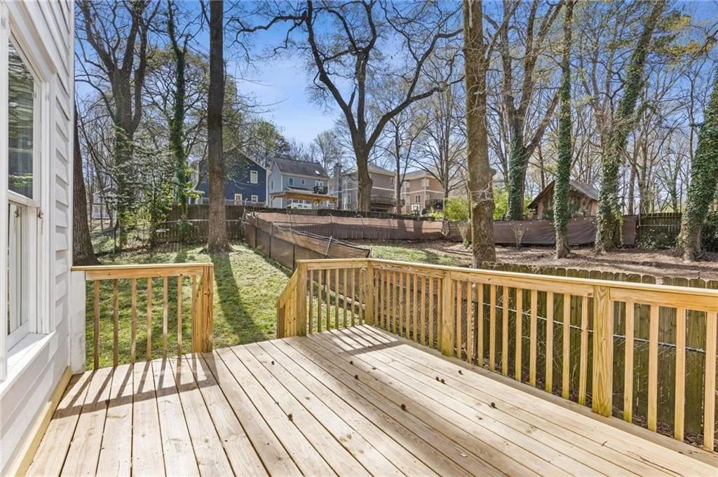 Wooden deck with a fenced backyard and a residential view