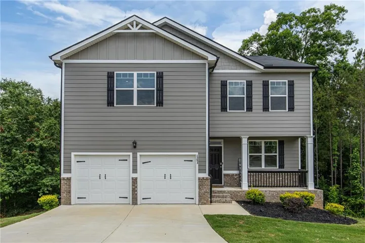Two-story residence featuring grey horizontal siding and shake accents