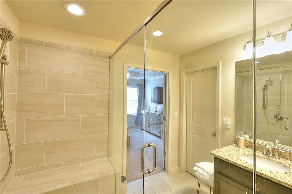 Full bath featuring a stall shower, vanity, and recessed lighting