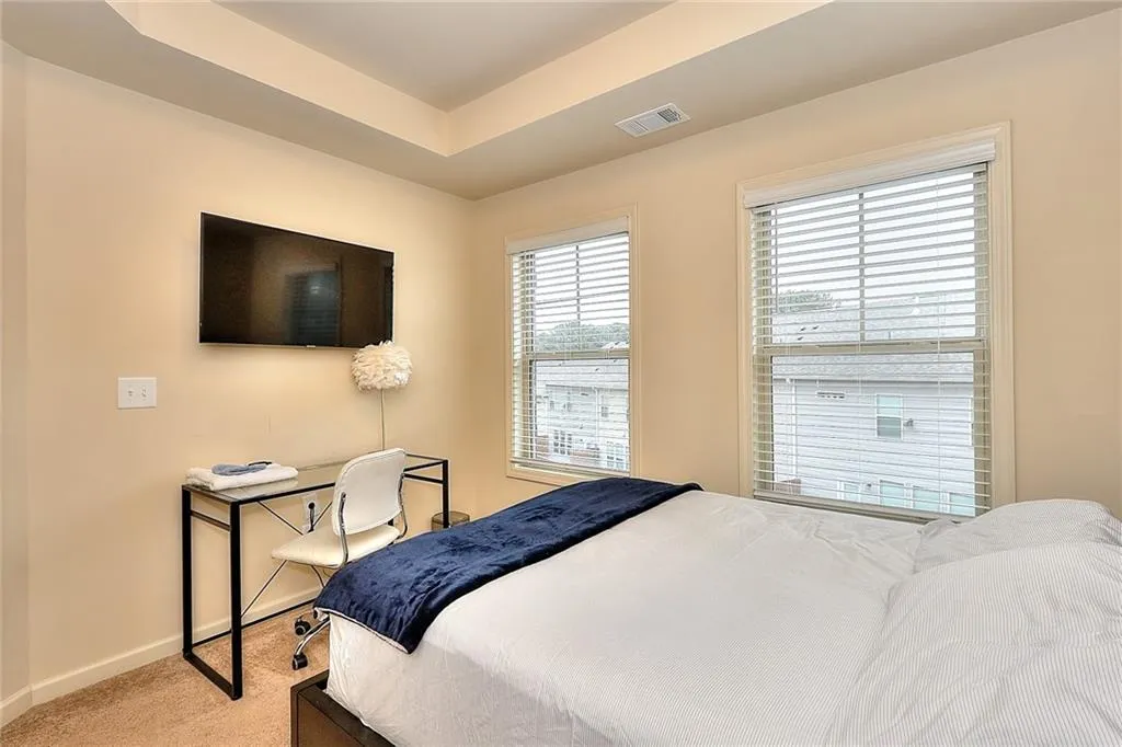 Carpeted bedroom featuring baseboards