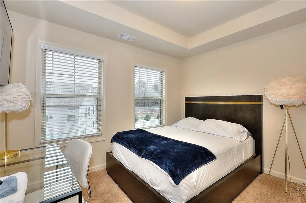 Carpeted bedroom with baseboards