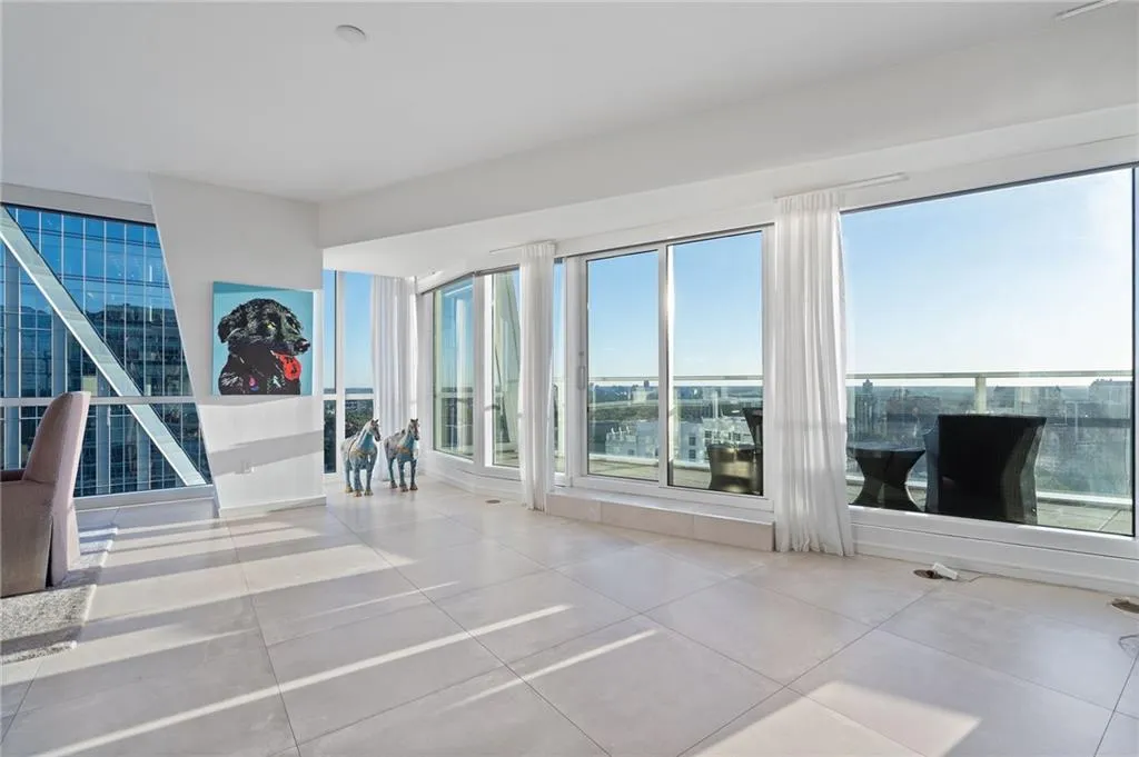 Empty room with plenty of natural light and tile patterned floors Empty room with plenty of natural light and tile patterned floors
