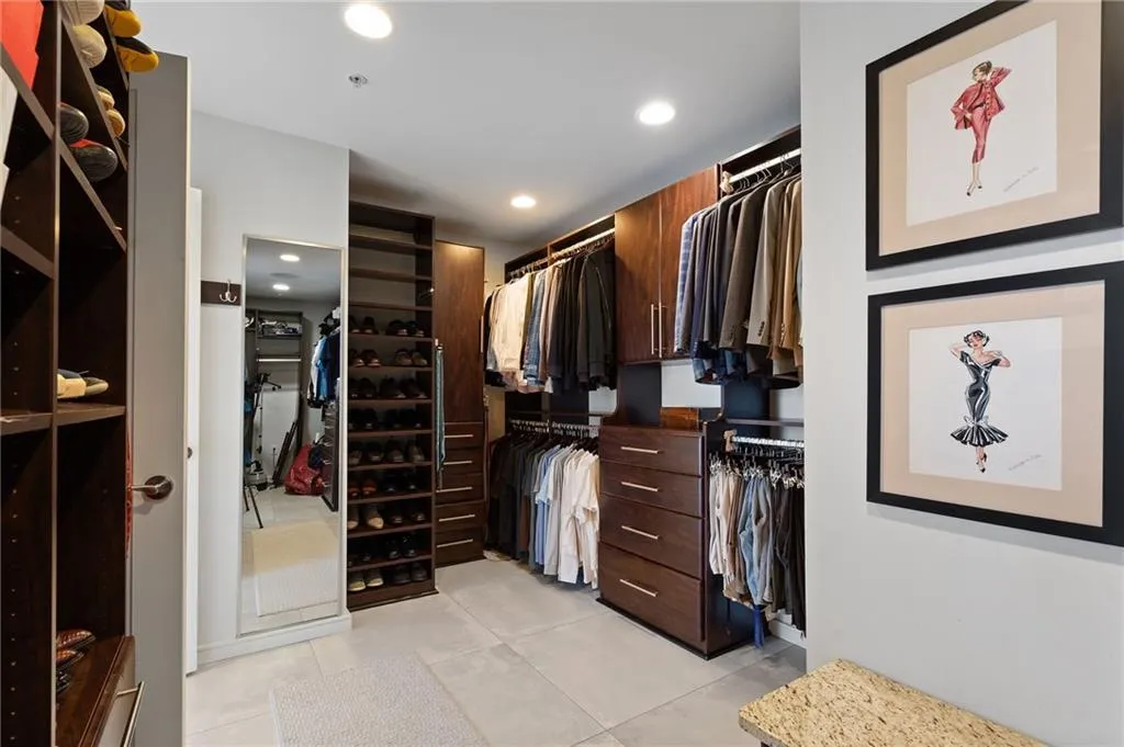 Walk in closet featuring light tile patterned floors Walk in closet featuring light tile patterned floors