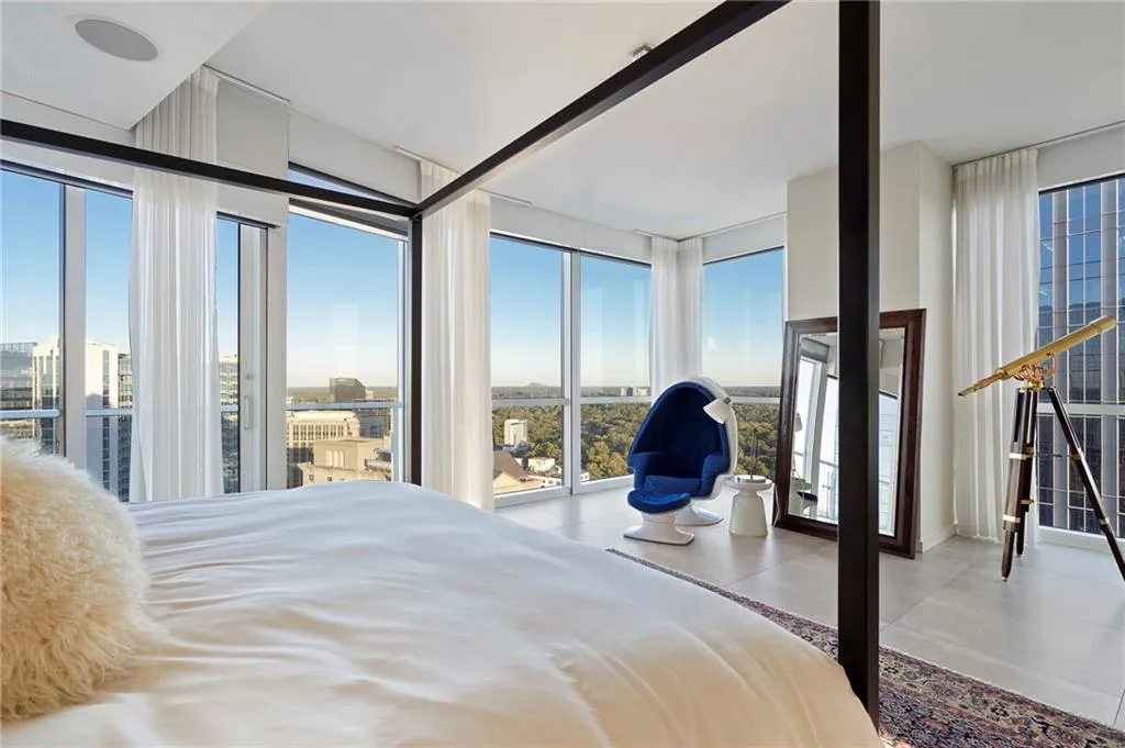 Bedroom with expansive windows, multiple windows, light tile patterned floors, and access to exterior Bedroom with expansive windows, multiple windows, light tile patterned floors, and access to exterior