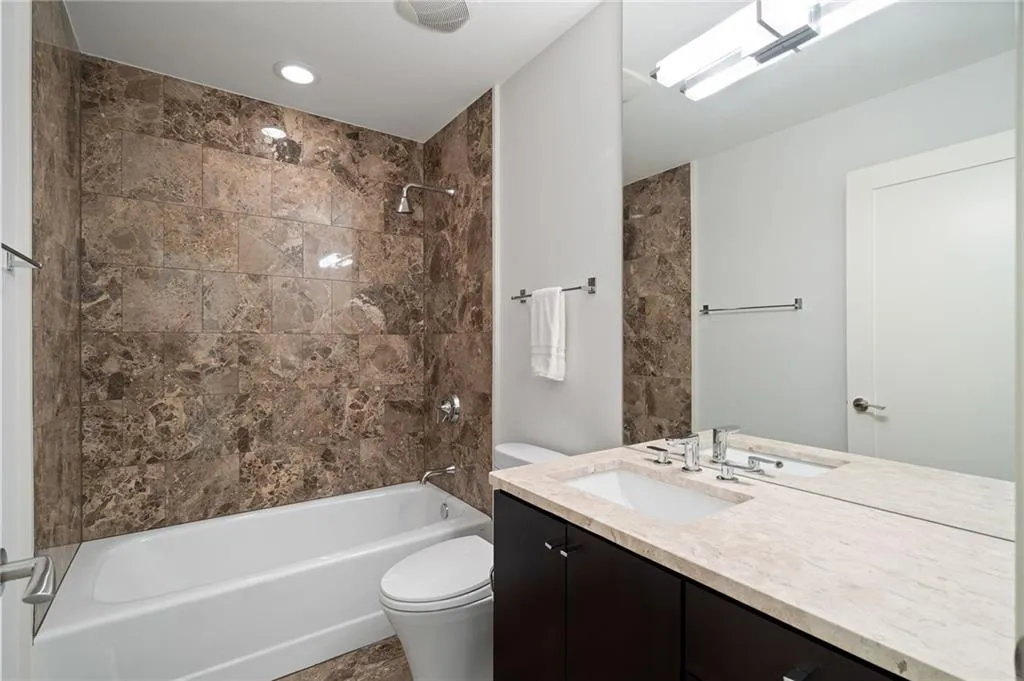 Bathroom featuring shower / washtub combination and vanity Bathroom featuring shower / washtub combination and vanity
