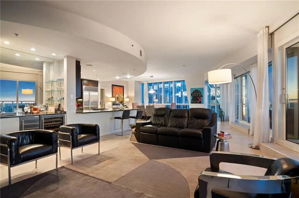 Living area with recessed lighting, bar, and light carpet Living area with recessed lighting, bar, and light carpet