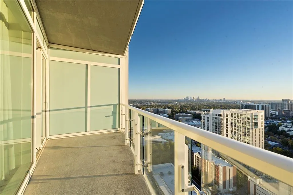 Balcony at dusk featuring a view of city Balcony at dusk featuring a view of city