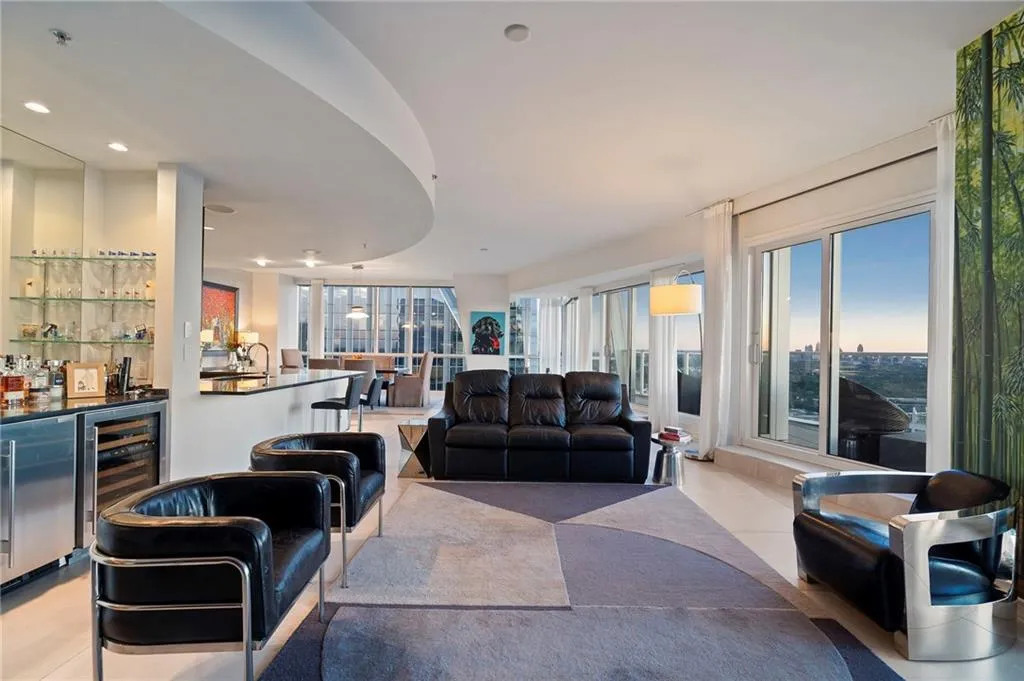 Living area with wine cooler, a bar, recessed lighting, and a view of city Living area with wine cooler, a bar, recessed lighting, and a view of city
