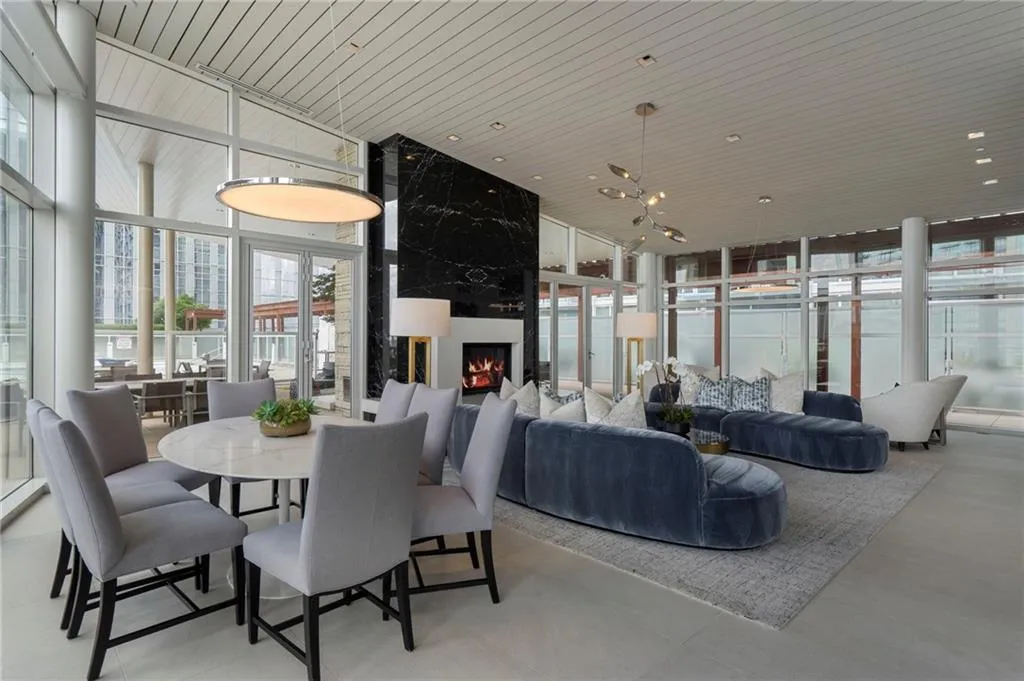 Dining room with floor to ceiling windows, a fireplace, wooden ceiling, and plenty of natural light Dining room with floor to ceiling windows, a fireplace, wooden ceiling, and plenty of natural light