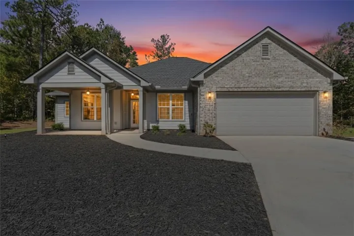Contemporary ranch-style exterior featuring a light gray brick facade and complementary siding