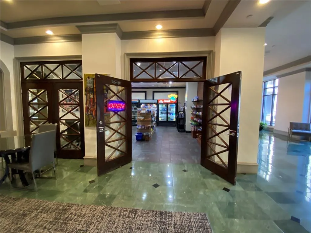 Foyer featuring arched walkways and french doors