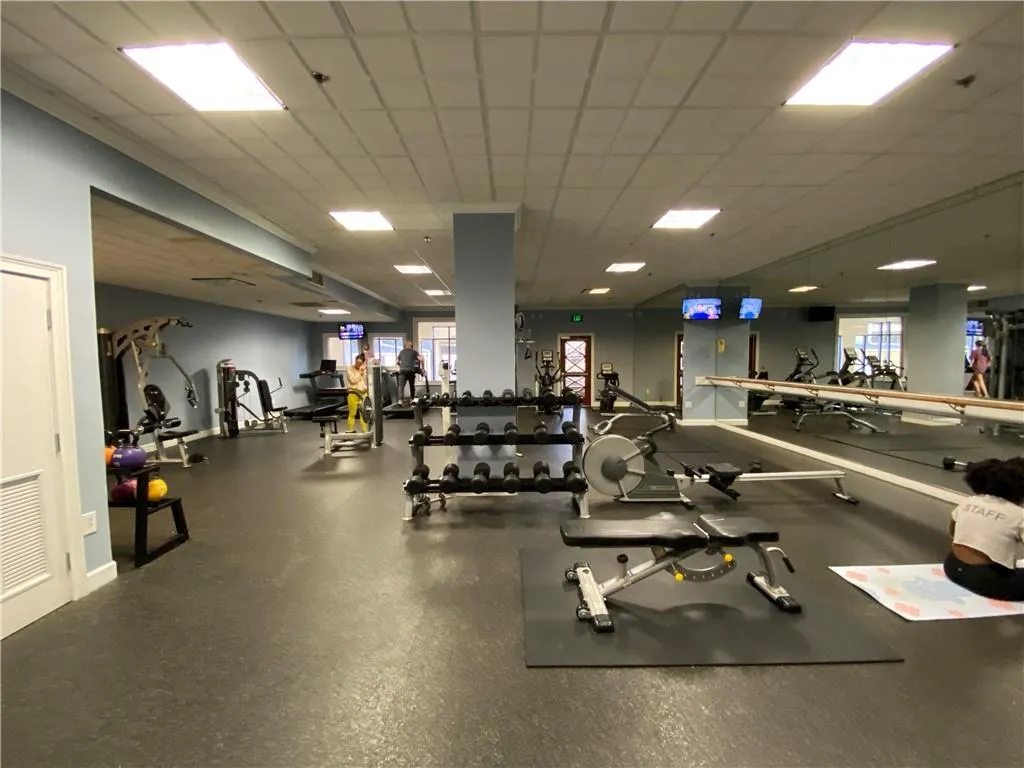 Workout area with a drop ceiling and visible vents