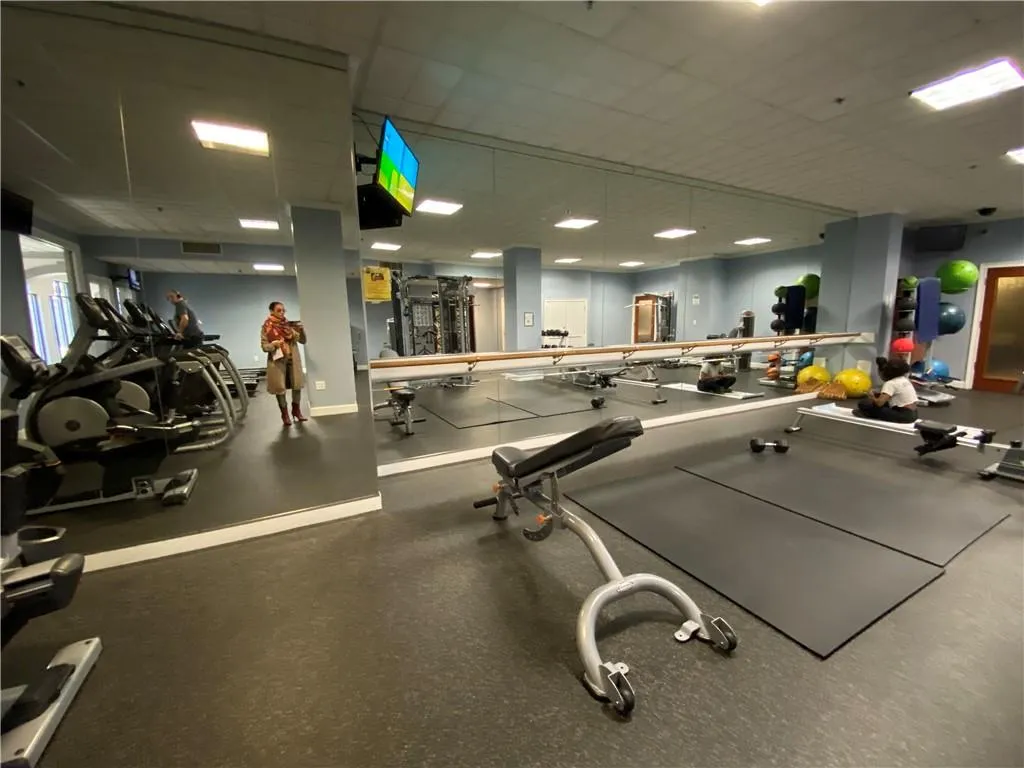Workout area with a paneled ceiling, baseboards, and visible vents
