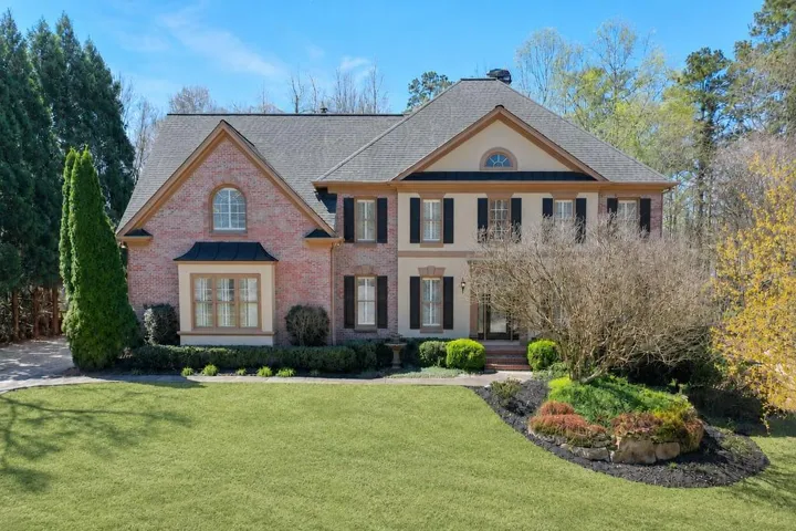 Brick exterior with stucco accents and a gabled roof