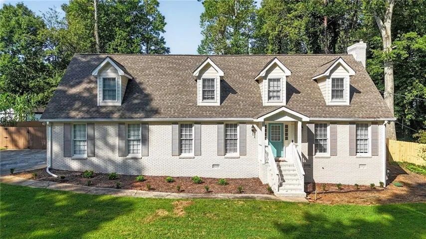 White brick exterior with gray window shutters